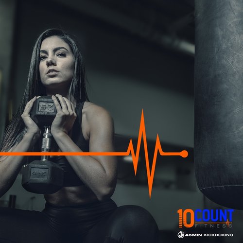 Girl lifting in the gym with bag and orange heart rate